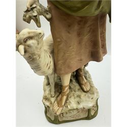Pair of Royal Dux figures, no. 1115, modelled as a shepherd with a goat by his side and a shepherdess feeding a lamb, each wearing flowing green and pink robes with gilt detailing, with pink triangle mark beneath, H51cm