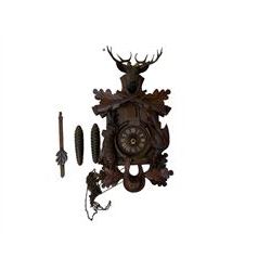 A 20th century cuckoo clock and weight driven German wall clock.