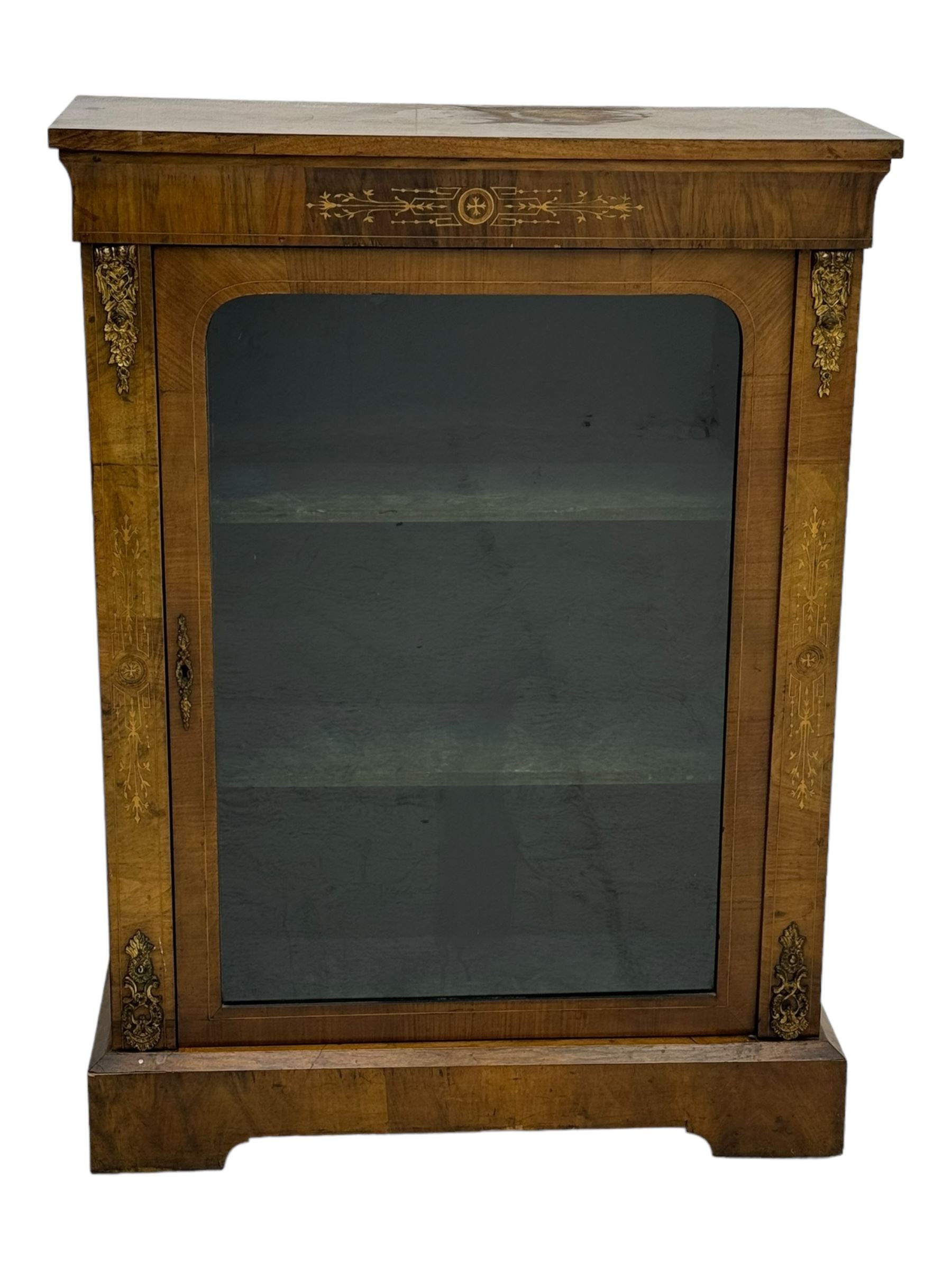 Late Victorian walnut pier cabinet, projecting cornice over frieze inlaid with foliate motifs, single glazed door flanked by ormolu mounts, enclosing shelved interior, on plinth base