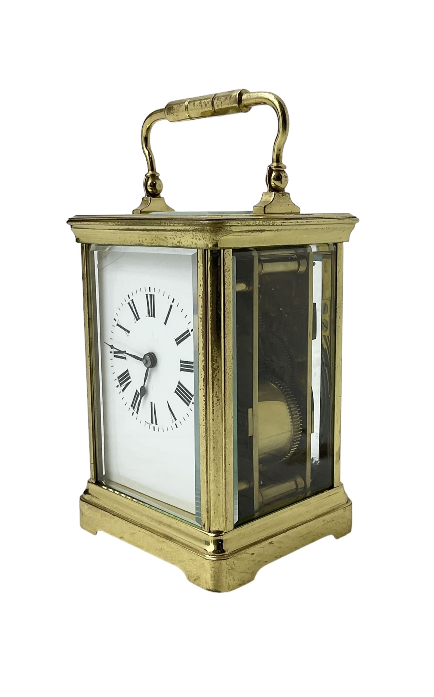 20th century -  8-day striking carriage clock in a corniche case, with an enamel dial , Roman numerals, minute track and steel spade hands, twin train going barrel movement with a lever platform escapement and rack striking, sounding the hours and half hours on a coiled gong.  With key.