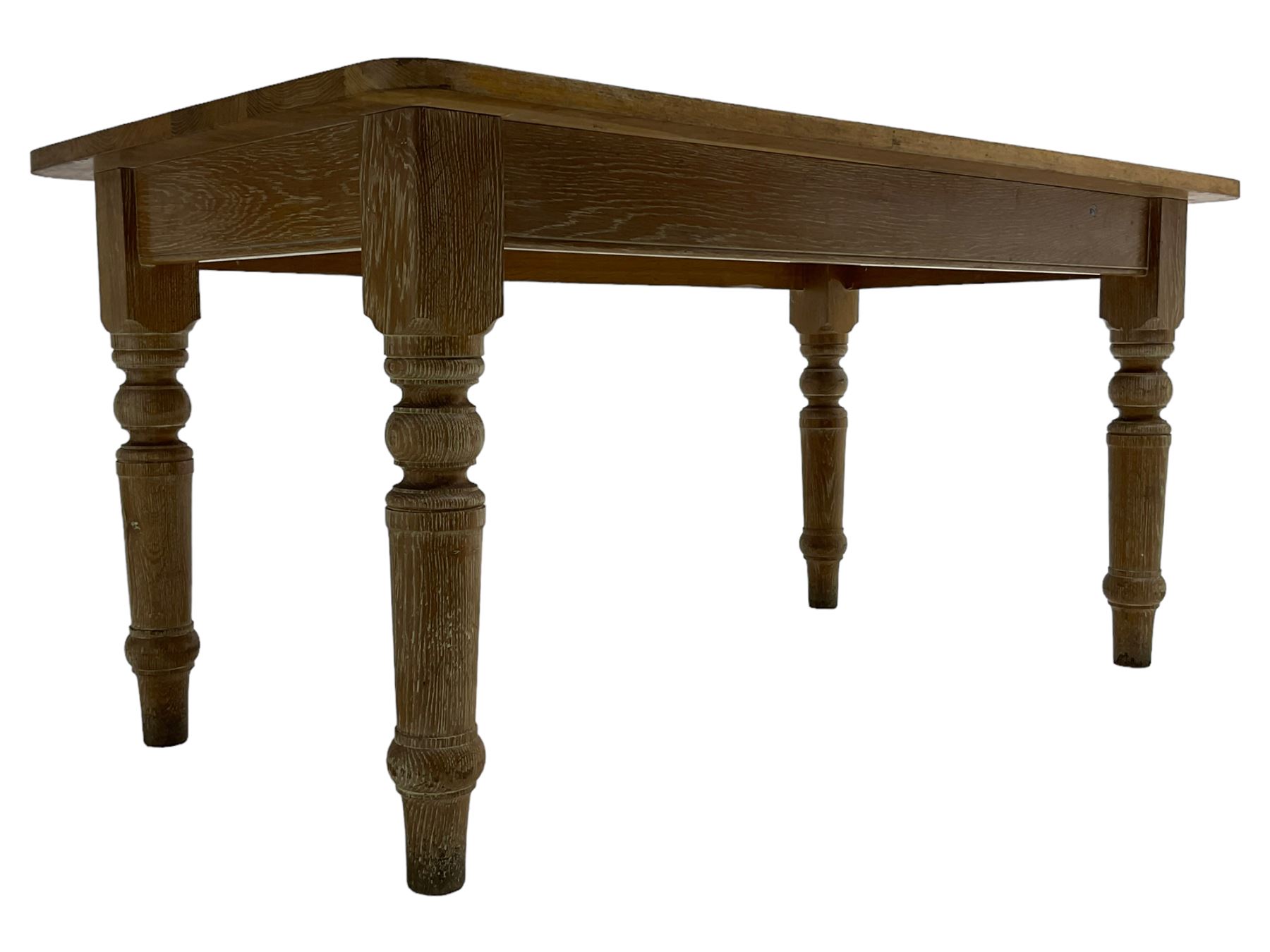 Limed oak dining table, rectangular top with rounded corners, on turned supports