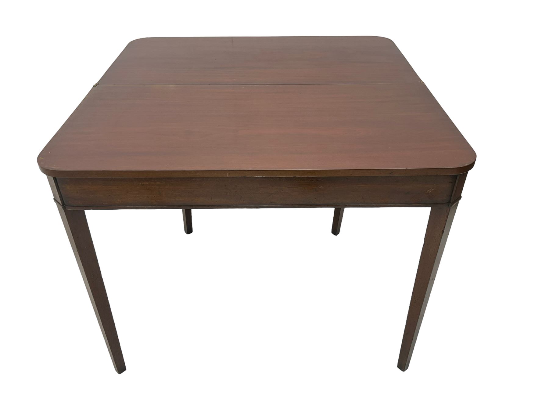 Early 20th century mahogany tea table, fold-over swivel top with rounded corners, raised on square tapering supports