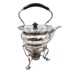 Early 20th century silver spirit kettle and burner, of oval form, with oblique gadrooned rim, engraved crest and ebonised handle and finial, the stand upon three scrolling pad feet, hallmarked Goldsmiths Silversmiths Company, London 1913, total H31cm