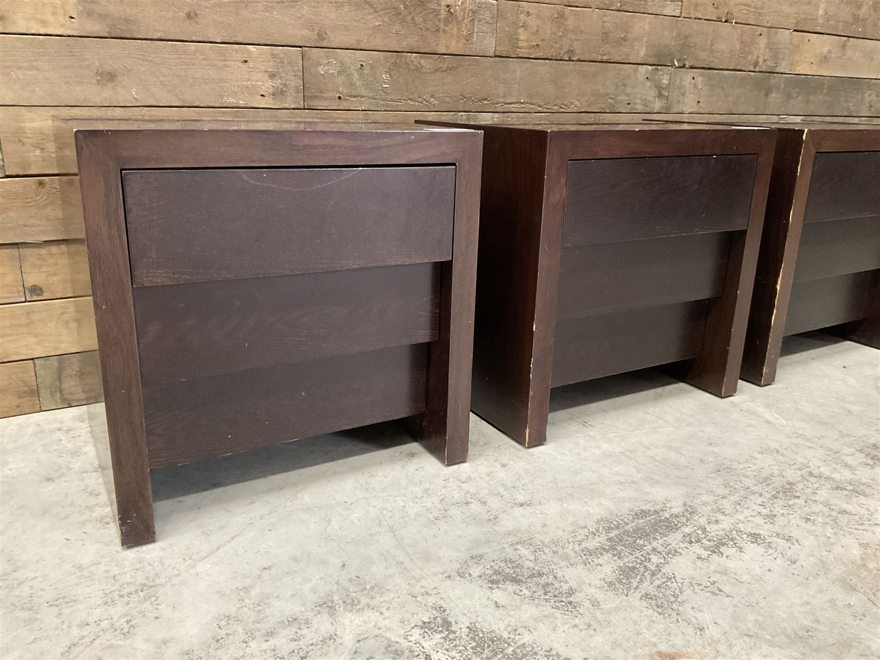 Four rosewood bedside chests, fitted with three stepped soft-close drawers