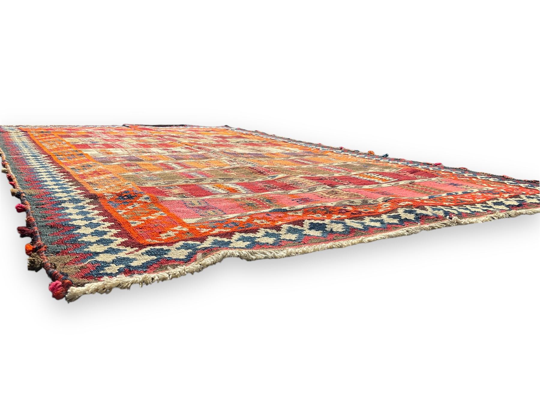 Southwest Persian Qashqai Kilim ground rug, featuring a series of horizontal striped panels each filled with intricate geometric designs, enclosed by a dark blue and ivory border with stylised star and zigzag motifs