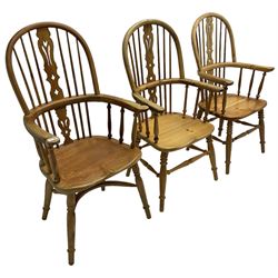 Near set of three 20th century pine Windsor chairs, high hoop stick back with pierced splat over shaped saddle seat, raised on ring turned supports