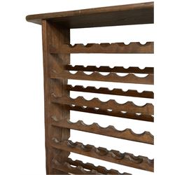 Large reclaimed oak eight tier wine rack, rectangular top over eight racks each with ten bottle divisions, on end supports