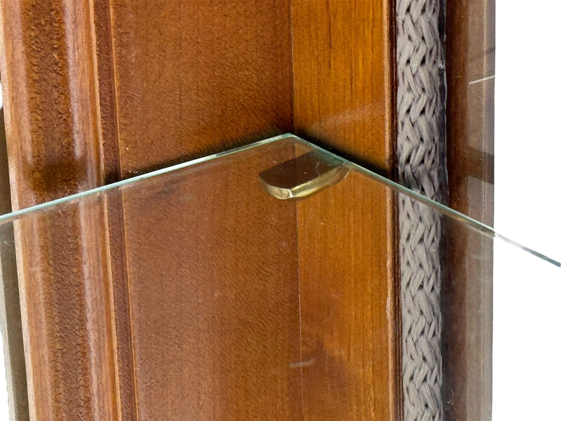 20th century cherry wood display cabinet, projecting cornice over two glazed doors with bevelled panes flanked by fluted support columns, enclosing three adjustable glass shelves with mirror-back surface, supported by shaped bracket feet