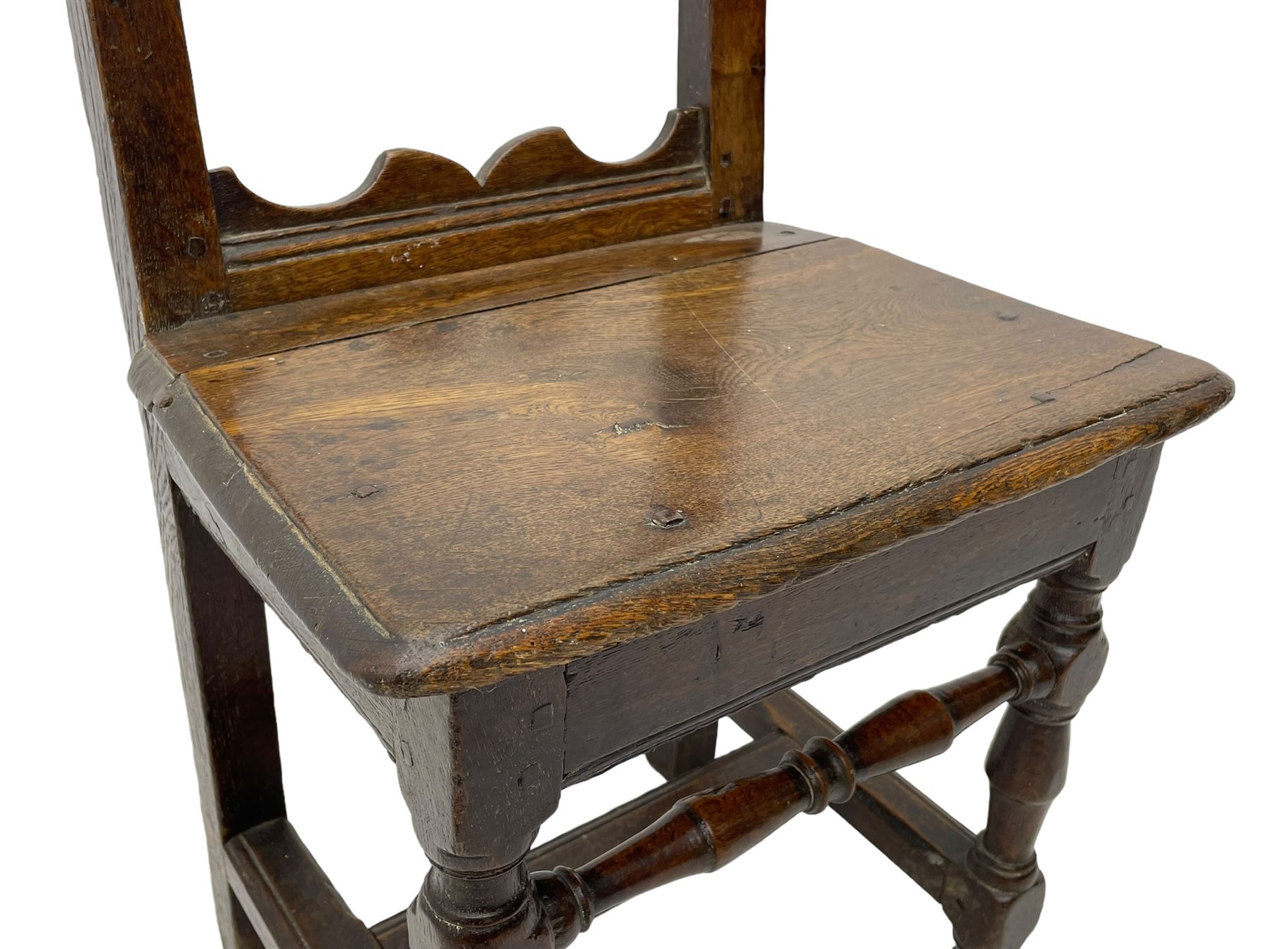 Small late 17th century oak side chair, open frame back with shaped upper and lower brackets, moulded plank seat, on turned supports united by moulded H-shaped stretchers