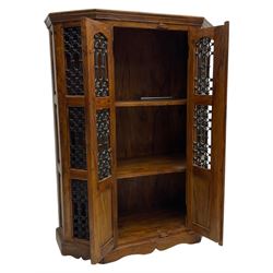 Hardwood and wrought iron cabinet, enclosed by two doors, on plinth base 