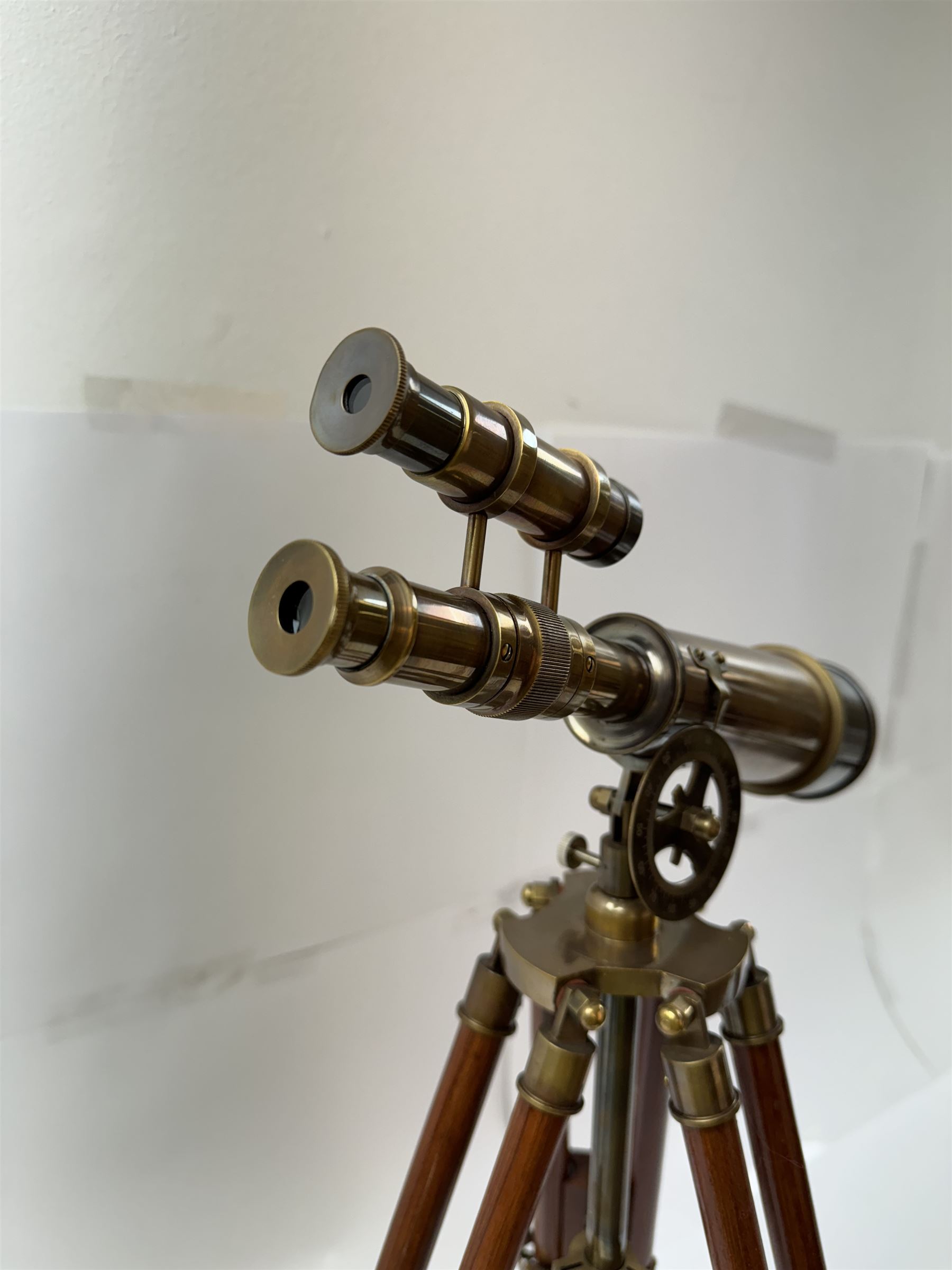 Brass telescope upon a wooden adjustable tripod, H55cm 