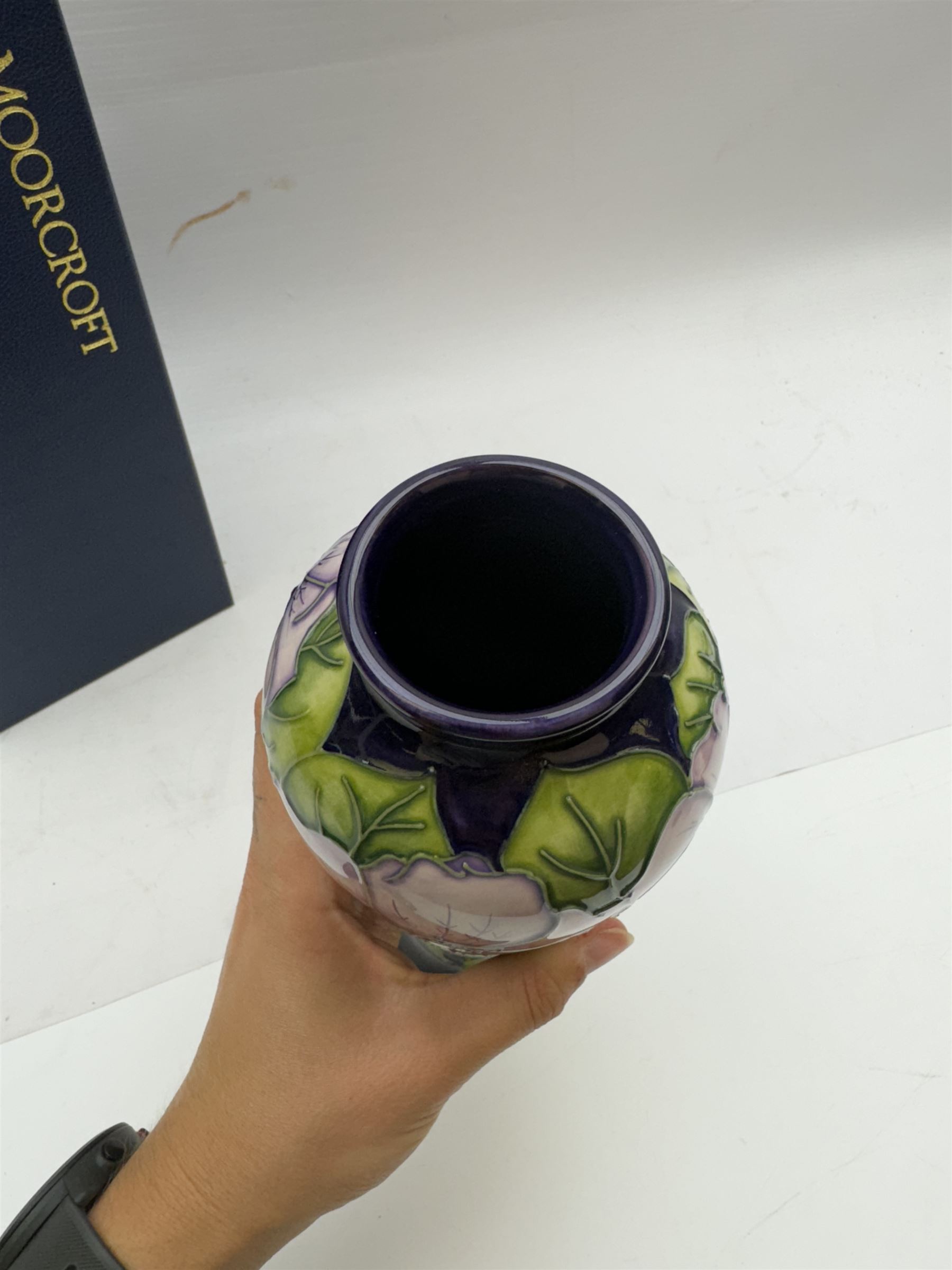 Moorcroft vase in Petunia pattern upon a purple ground, of tall baluster form, marked made for collectables to the base,  with original box, H21cm