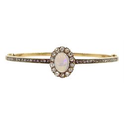 Early 20th century gold opal and diamond hinged bangle, the central opal and rose cut diamond cluster, with channel set rose cut diamonds set either side