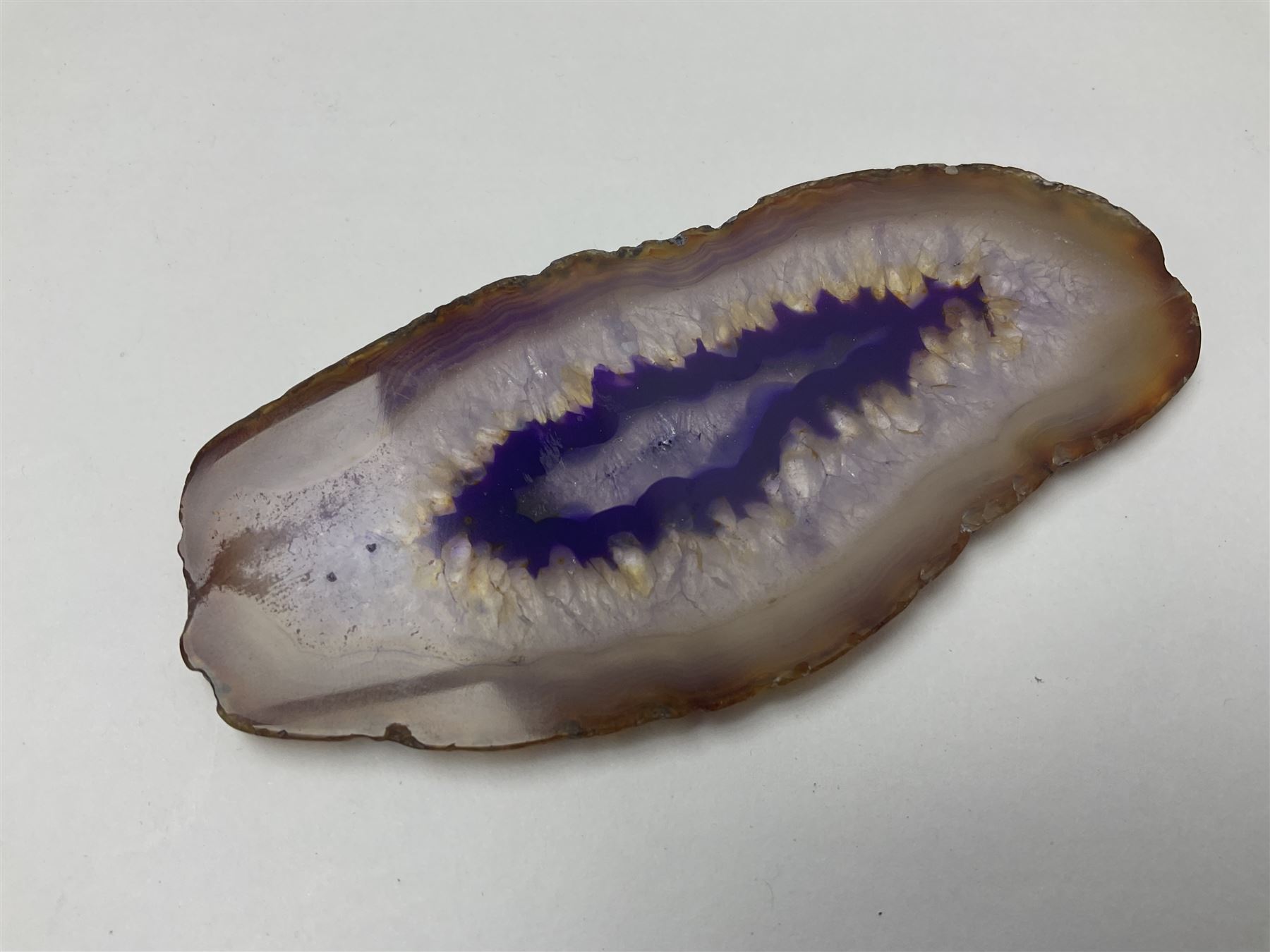 Three purple agate slices, polished with rough edges, of various sizes largest H7cm, L10cm