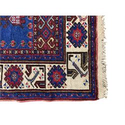 Turkish Yuruk indigo ground rug, the field decorated with geometric architectural designs, the guarded ivory border with repeating stylised plant motifs