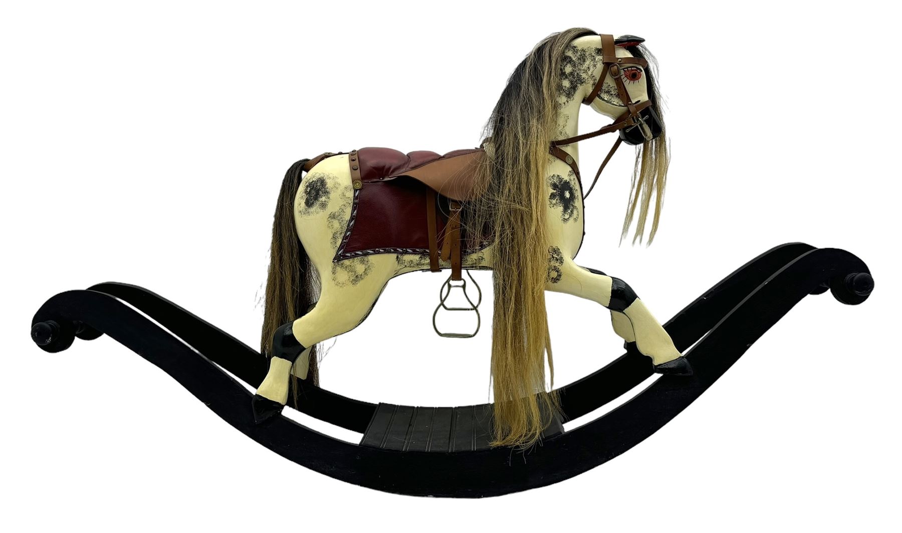 Mid-to-late 20th century carved wooden rocking horse, in dapple grey finish with leather saddle and bridle, mounted on a black painted rocking frame with shaped ends