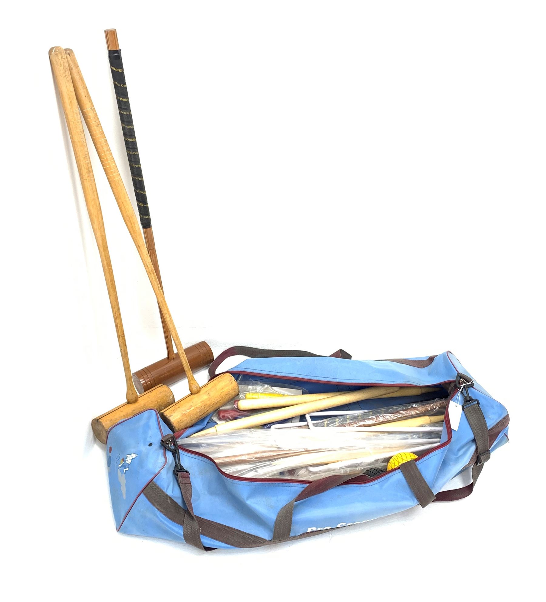 A croquet set, with wooden mallets, hoops, and balls, in carry bag. 