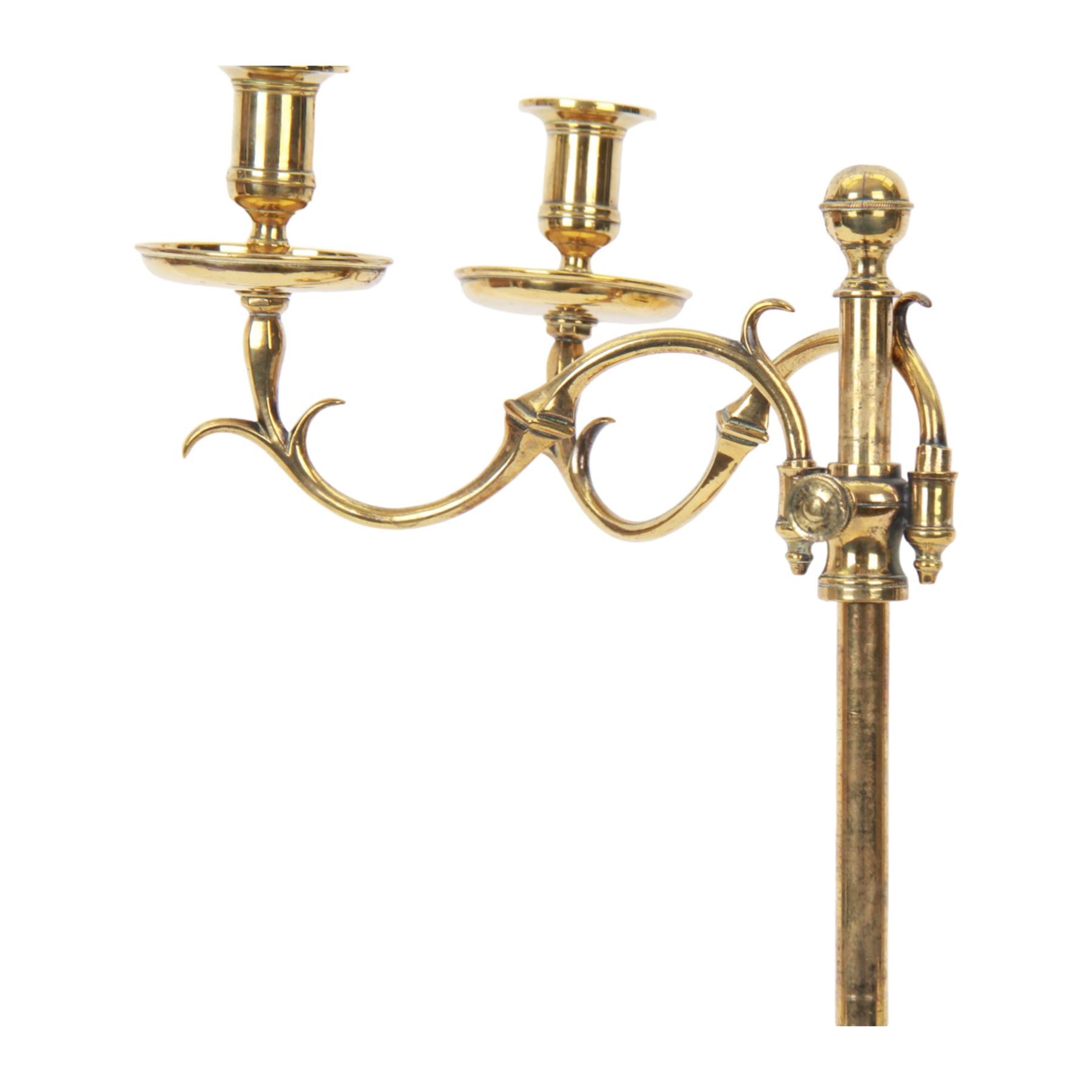 19th century brass adjustable candlestick, the spreading circular base leading to a basal knopped stem supporting adjustable twin scroll arms with urn shaped sockets above circular drip pans, H38cm W43.5cm