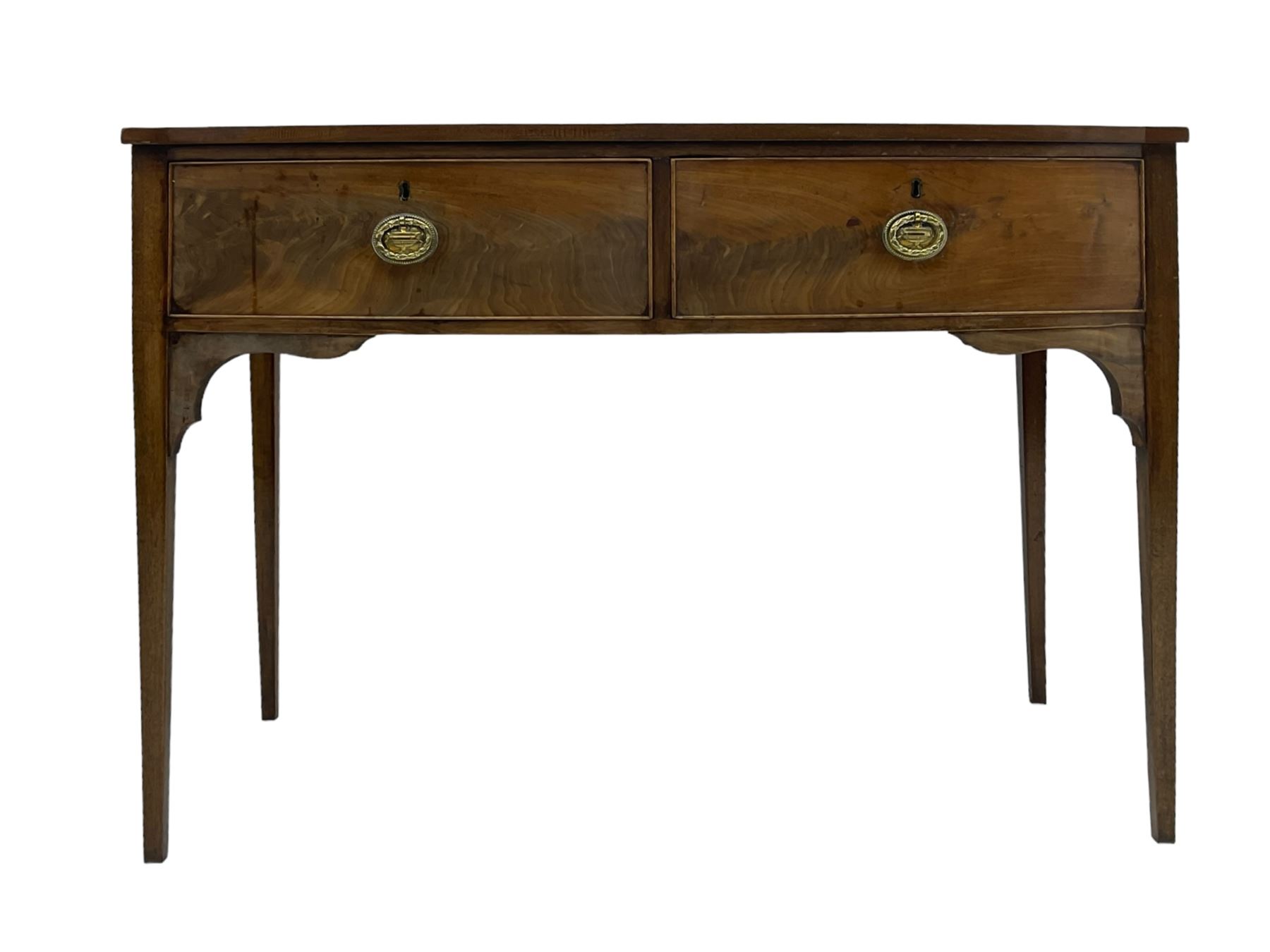 19th century mahogany bow-front serving table, fitted with two cock-beaded drawers with oval pressed brass handles decorated with urns, on square tapering supports 