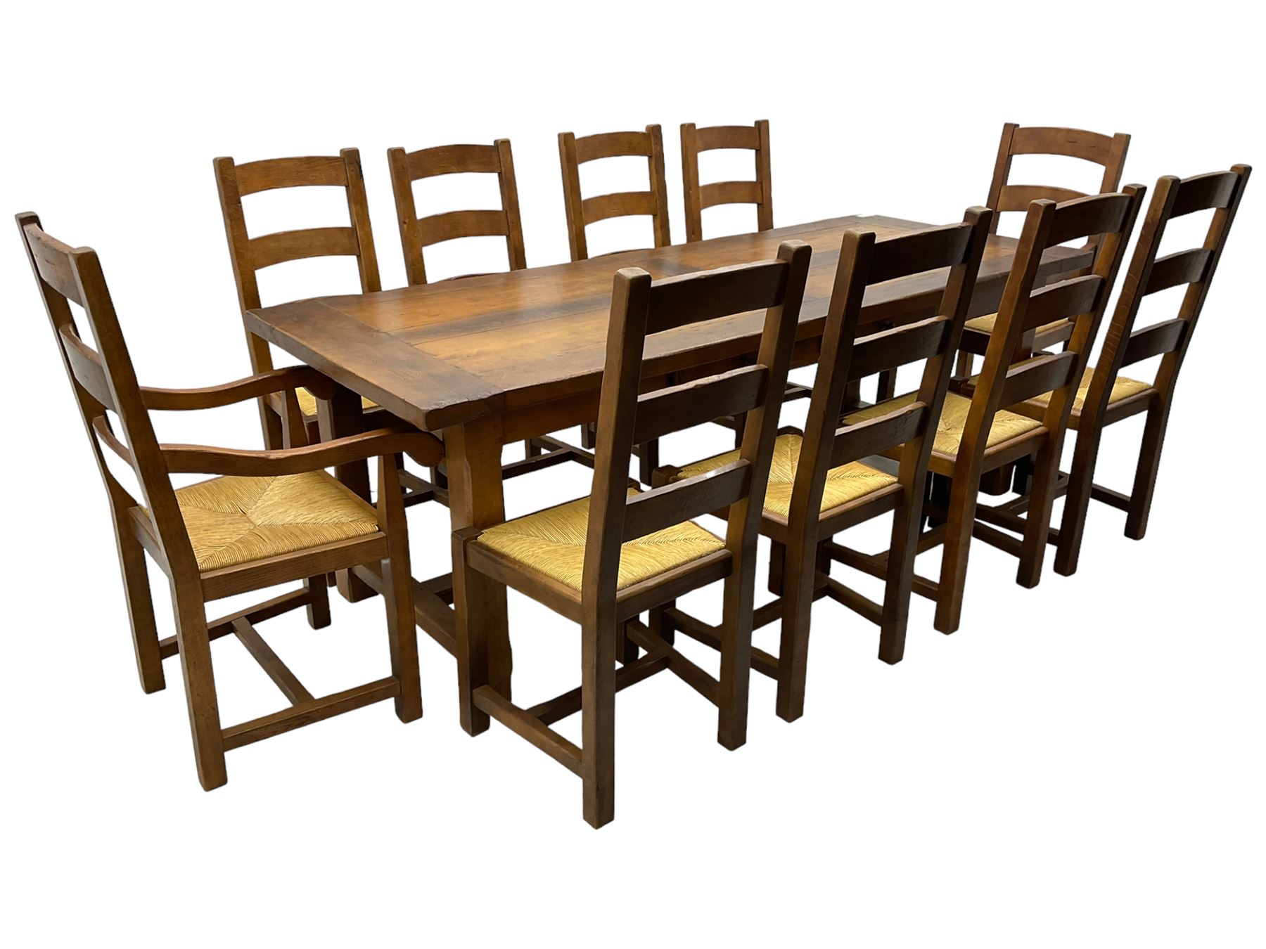 Antix Furniture - oak extending refectory dining table, rectangular plank top with two additional leaves and two drawers to the longer side, on square supports connected by H-stretcher; set of ten (8+2) ladder back dining chairs with rush seats