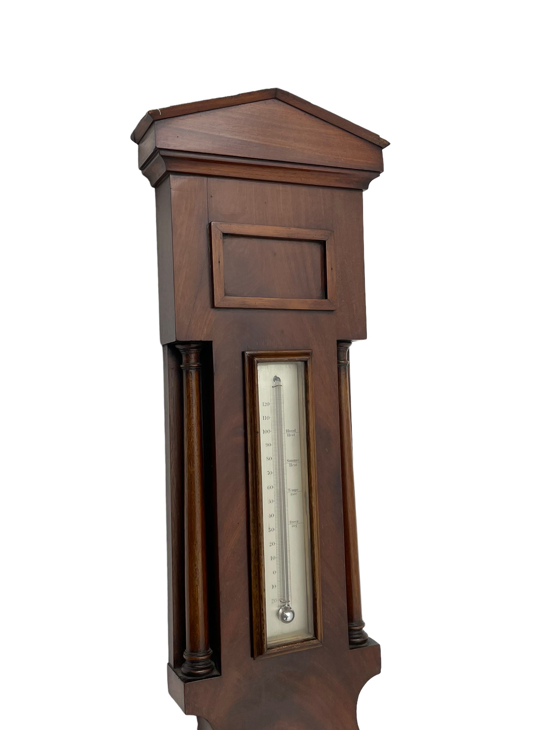 McDowall of Edinburgh - mid-Victorian mahogany mercury wheel barometer, with a gable pediment and cavetto moulded square base, cast brass bezel enclosing a 10-inch silvered register with an engraved symmetrical pattern to the centre and barometric air pressure in inches, boxed mercury thermometer with a silvered Fahrenheit scale flanked by turned wooden pilasters, brass recording hand button, rectangular spirit level signed McDowall, Edinburgh.
This barometer once formed part of the collection of Edwin Banfield, a leading authority on barometers and is illustrated in his book 