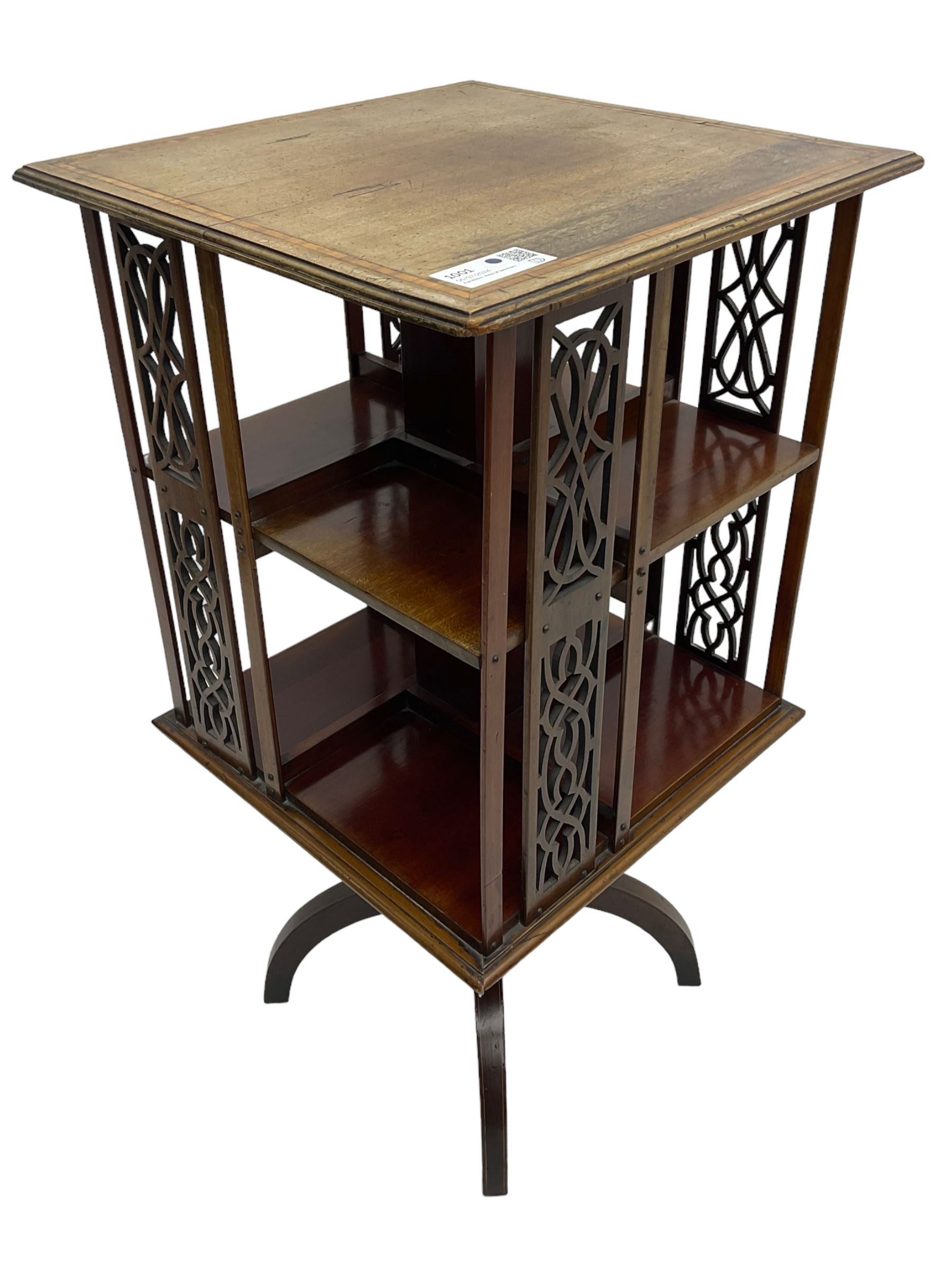 Edwardian mahogany revolving bookcase, square moulded top with satinwood band, two tiers with pierced vertical splats, on four curved supports 