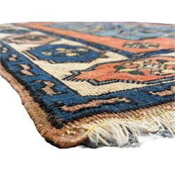 Turkish indigo ground rug, the shaped central field decorated with a central geometric stylised plant motif, enclosed with a guarded border decorated with contrasting motifs 