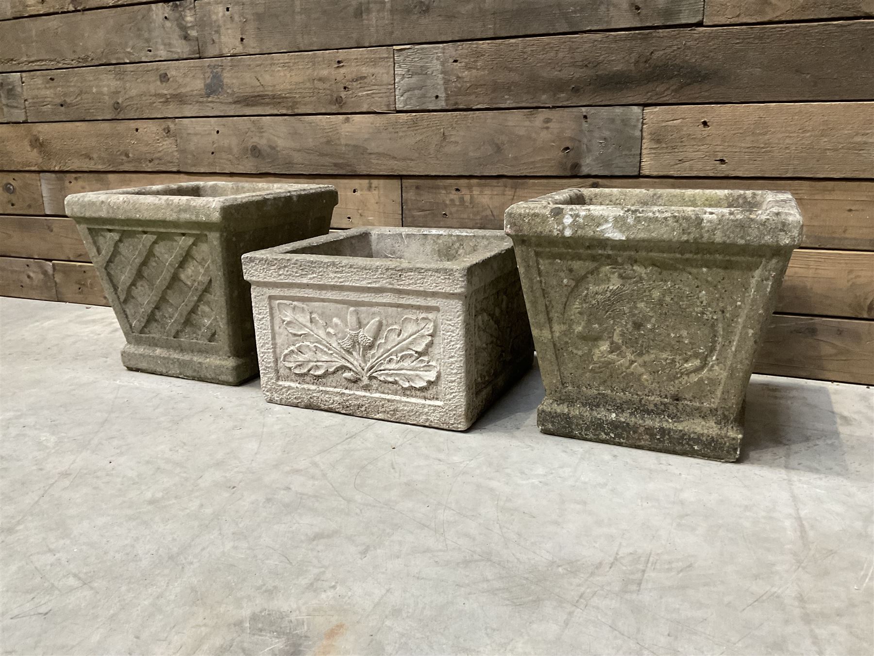 Pair of square cast stone planters, single planter with leaf decoration and a rectangular brick effect planter (4)