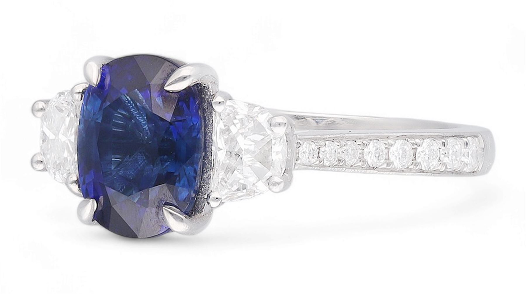 Platinum three stone oval cut sapphire and half moon cut diamond ring, with diamond set shoulders, hallmarked, sapphire 2.73 carat, total diamond weight approx 1.10 carat