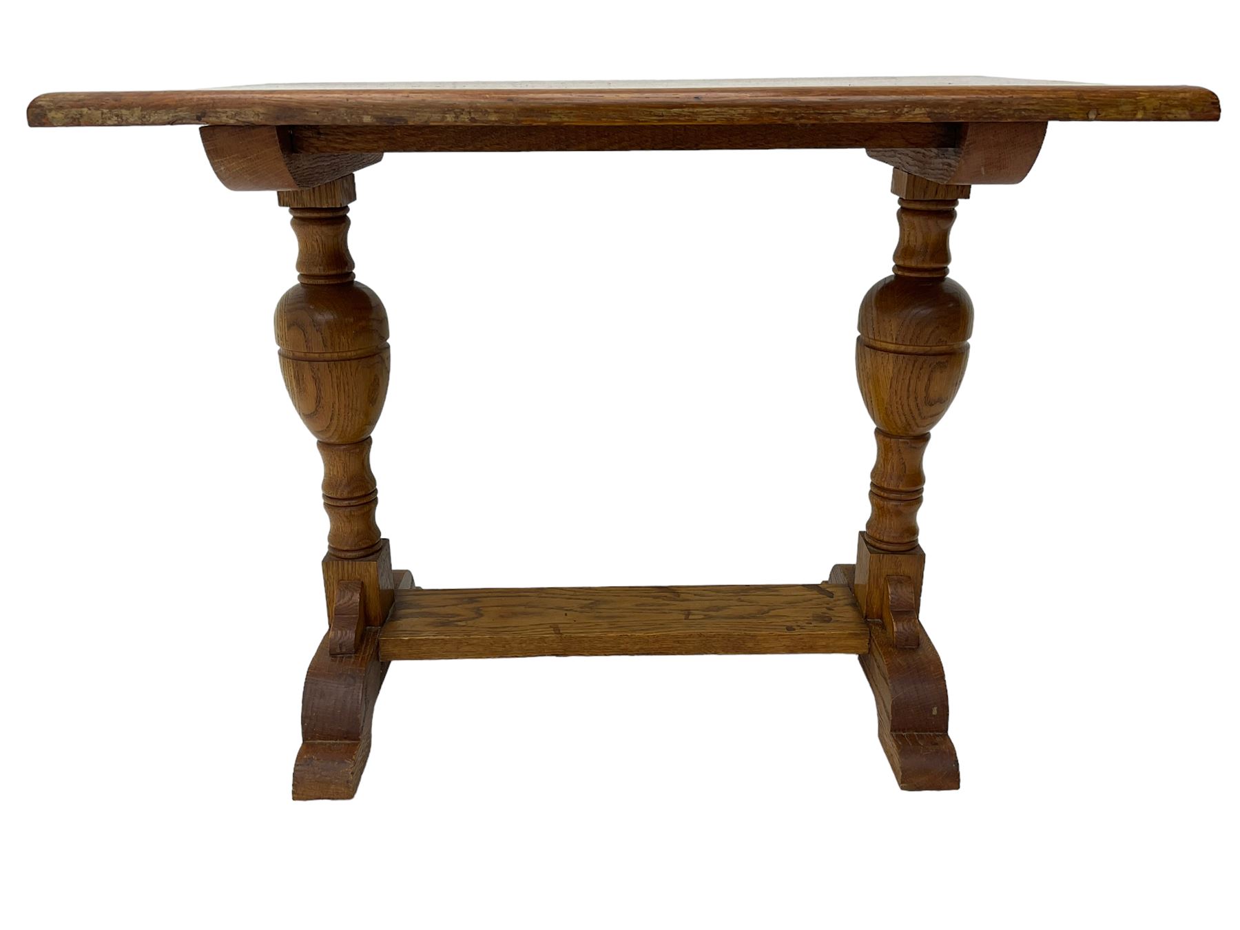 20th century oak occasional table, rectangular top on turned twin pillar supports, carved with squirrel motif, on shaped sledge feet united by stretcher 