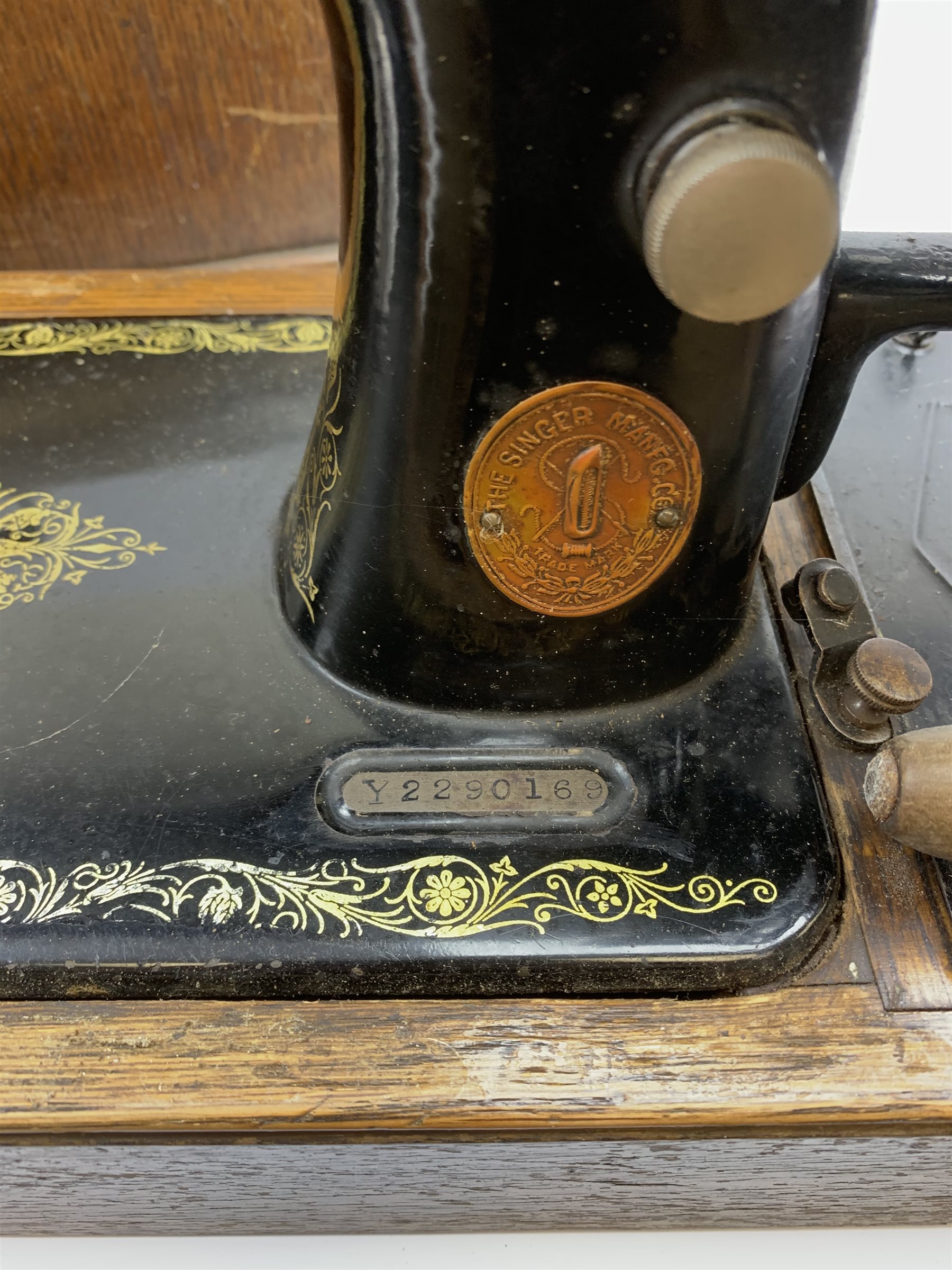 A cased vintage Singer hand crank sewing machine. 