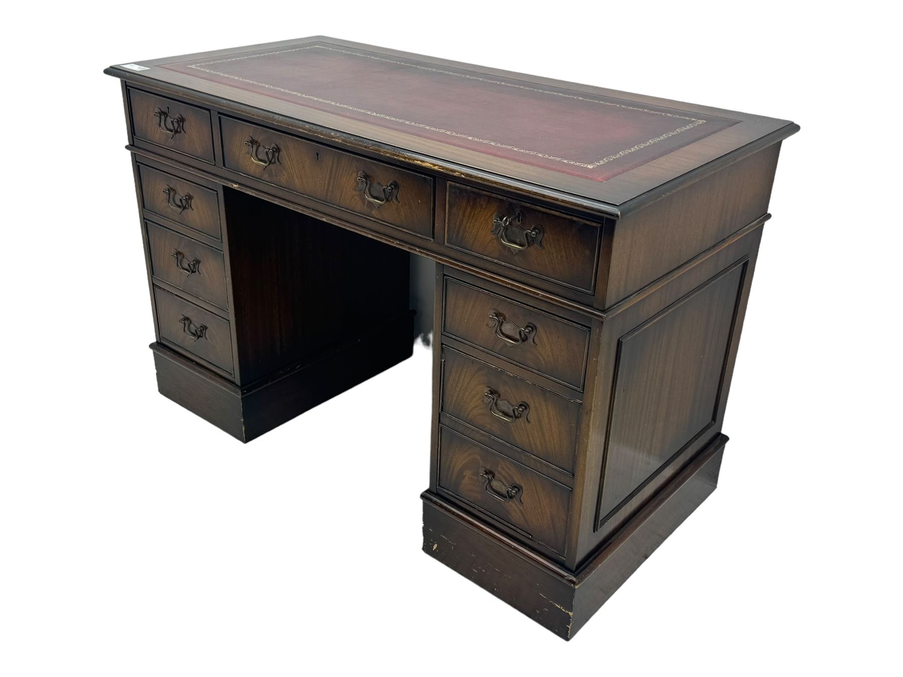 20th century mahogany twin pedestal desk, moulded rectangular top with red leather inset with gilt tooled border, central drawer over kneehole flanked by two banks of four graduating cockbeaded drawers, on plinth base