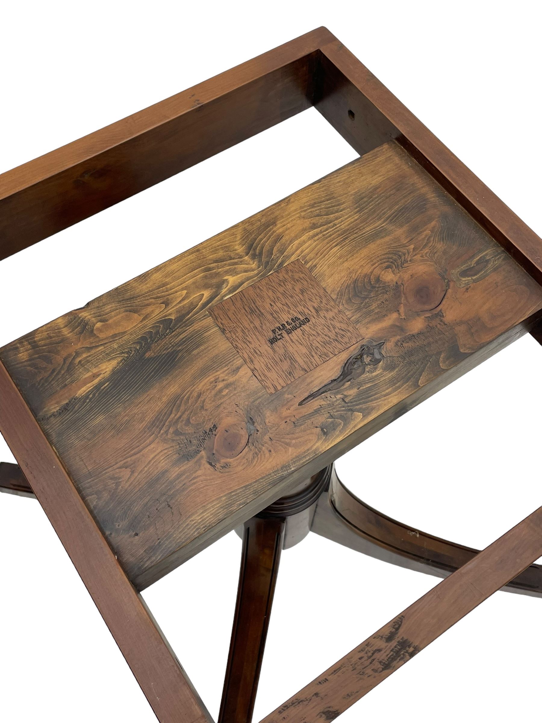 Georgian design inlaid chestnut wood centre table, the circular tilt-top inlaid with satinwood banding, gun barrel turned pedestal on four out-splayed supports, cast brass hairy paw castors, stamped 'P.H.R & Co. Holt, England' 