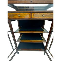 Edwardian mahogany bijouterie display cabinet, featuring satinwood inlay and crossbanding, hinged glazed top fitted with two banded drawers, over two astragal glazed doors enclosing black wool baize lined shelves with gold trim, supported by spade feet