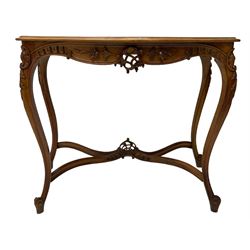 French design walnut console table, shaped top with inset grey marble panel, the frieze pierced and carved with scrolling foliage and applied flower heads, raised on cabriole supports with cartouche carved knees, united by shaped X-stretcher