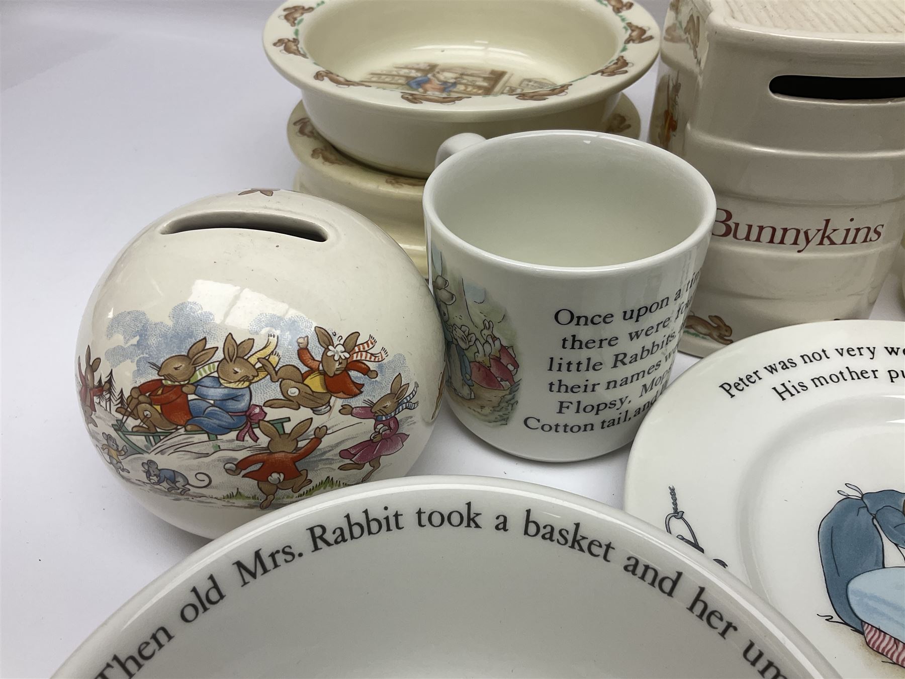 Collection of Royal Doulton Bunnykins and Wedgwood Peter Rabbit nursery ware, including cups, bowls, money boxes, etc 