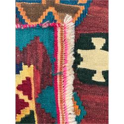 South West Persian Qashqai Kilim, crimson ground and decorated with three rows of geometric motifs, within zig-zag borders 