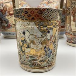 Pair of Japanese Satsuma vases decorated with four panels of figures in a landscape setting between patterned borders, character marks to the base, together with another pair of Satsuma vases and well bucket, largest vase H47cm