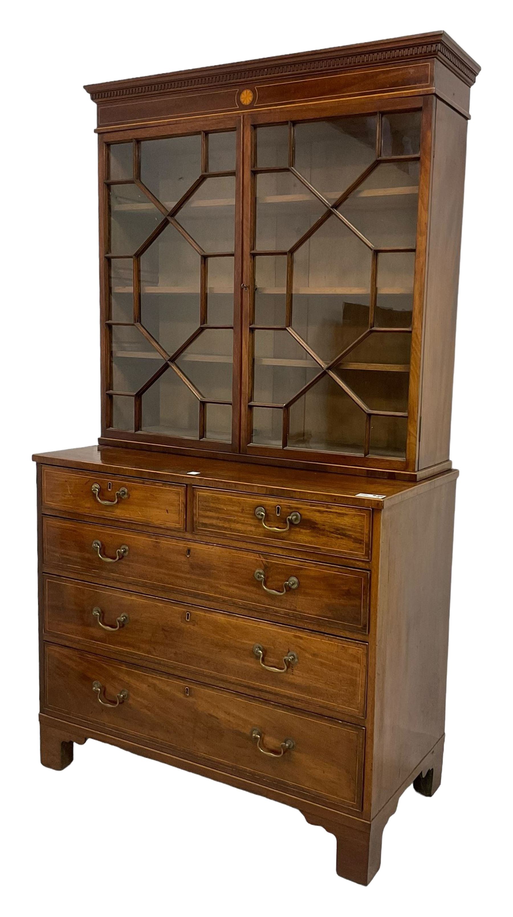 George III mahogany chest of drawers surmounted by a later bookcase, dentil cornice over inlaid frieze and astragal glazed doors, the chest fitted with two short over three long cock-beaded drawers, on bracket feet