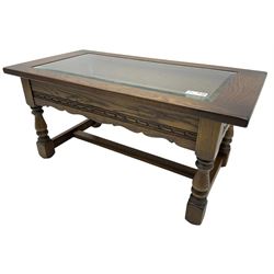 Old Charm - oak coffee table, rectangular top with glass inset over carved scalloped apron, on turned square supports connected by H-stretcher