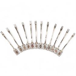 Set of twelve mid 20th century silver pickle forks, the terminals with enamelled playing c...