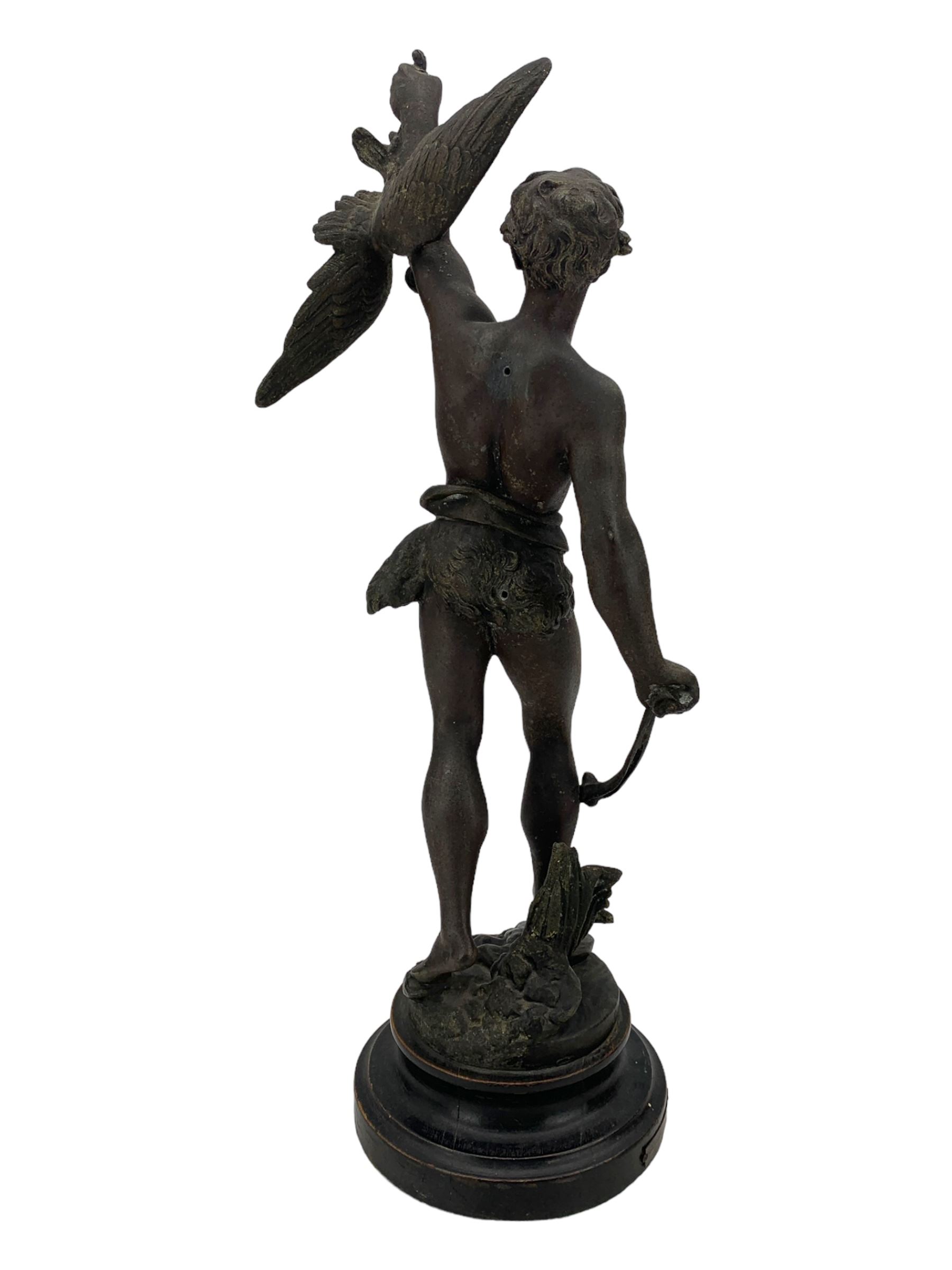 19th century French spelter figure 'Chasseur D'Aigles' on wooden base H48cm and a beaten copper circular tray inscribed with initials D61cm