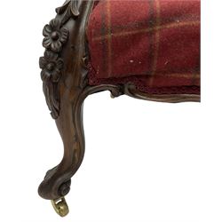 Victorian rosewood framed armchair, upholstered in buttoned tartan fabric, scrolled arm terminals graduating into cabriole supports with moulded flower head decoration and cartouche carved apron, over scroll feet with brass castors