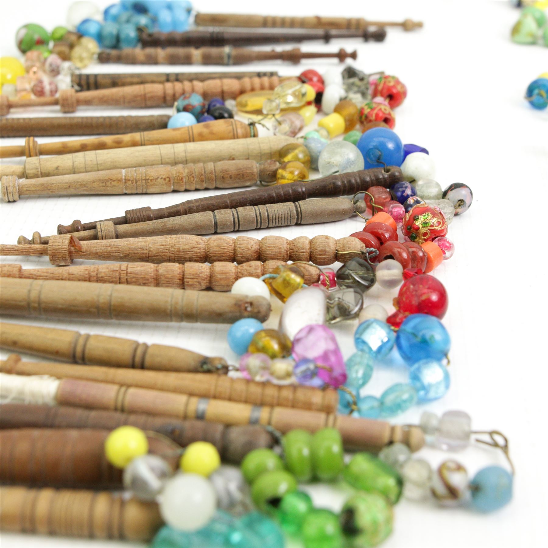 Collection of turned wooden lace maker's bobbins, including 19th century and later examples, mostly with glass spangles and turned shafts (100 approx)