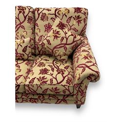 Contemporary upholstered three-seat sofa, scroll arms and loose cushions, embossed beige ground fabric with red and gold floral motifs, on tapered wooden supports