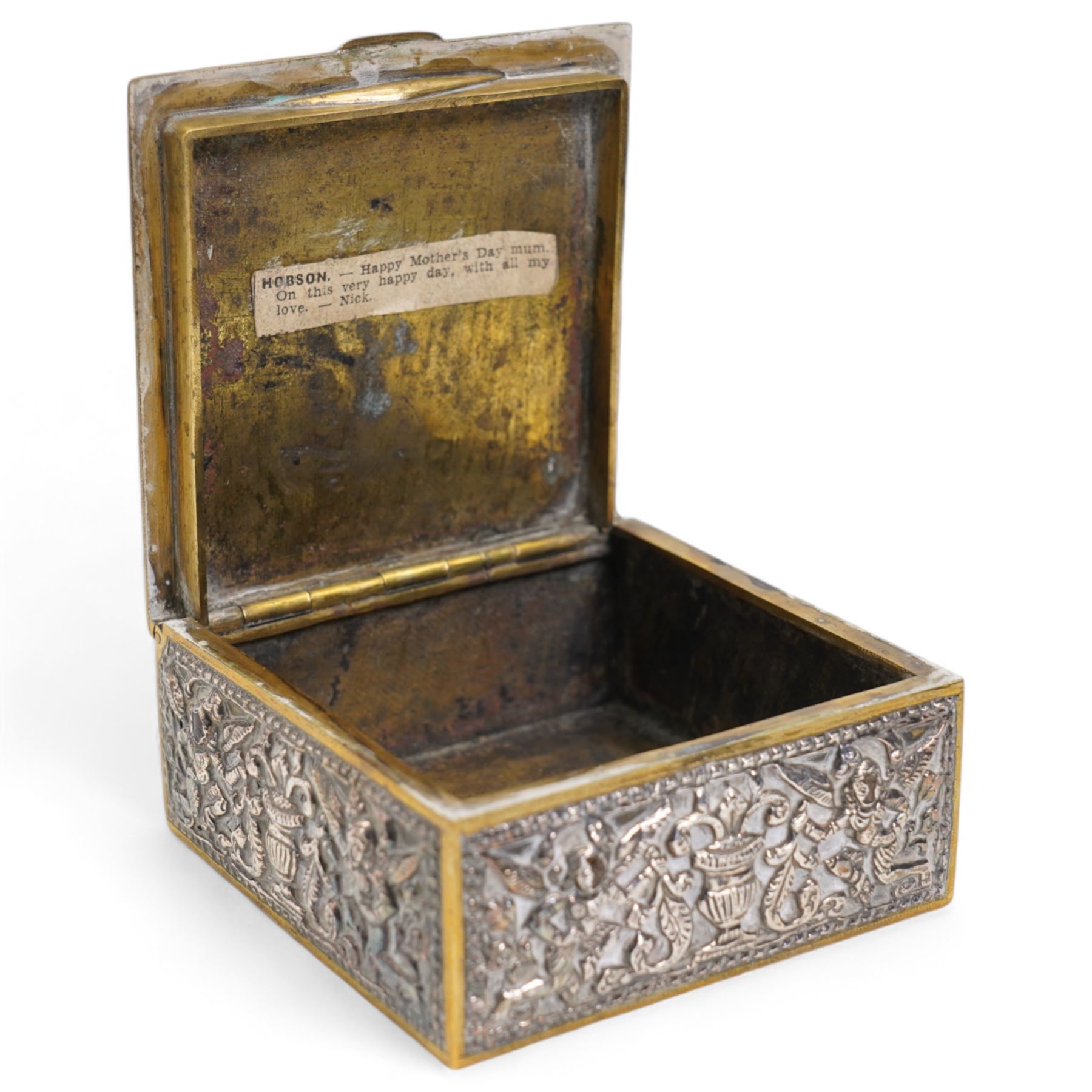 Pair of silver cylindrical dressing table boxes and covers embossed with trailing foliage H7cm, silver upright table photograph frame Birmingham 1909, Indian white metal and glass paperweight and a silver on copper trinket box