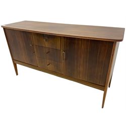 Mid 20th century teak sideboard, rectangular top with rounded corners over three central drawers, flanked by two cupboard doors enclosing shelves, raised on tapered supports