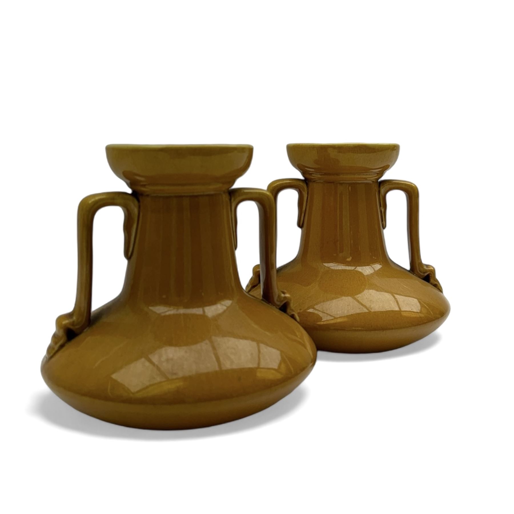 Christopher Dresser for Linthorpe Pottery, pair of twin handled vases, ochre glaze, H14cm