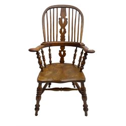 Elm and beech high back Windsor chair,  high hoop back with pierced splat and spindle supports over shaped saddle seat, raised on ring turned supports united by H-stretcher