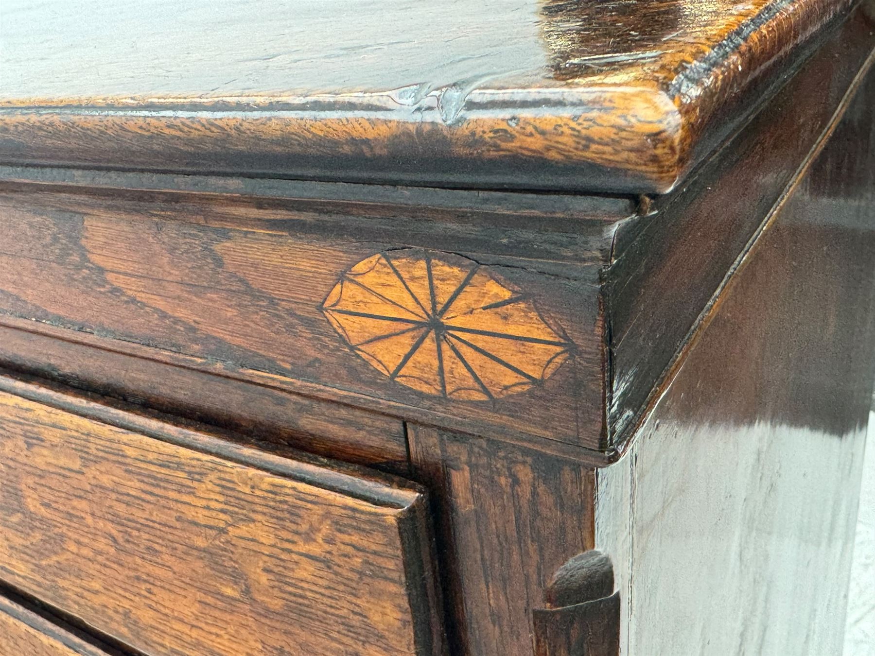 George III oak chest, rectangular top over frieze with inlaid with inscription panels 'Mary Rees' and fan motifs, frieze drawer over two short and three long graduating drawers, fitted with brass swan-neck handles and oval escutcheons, on bracket feet